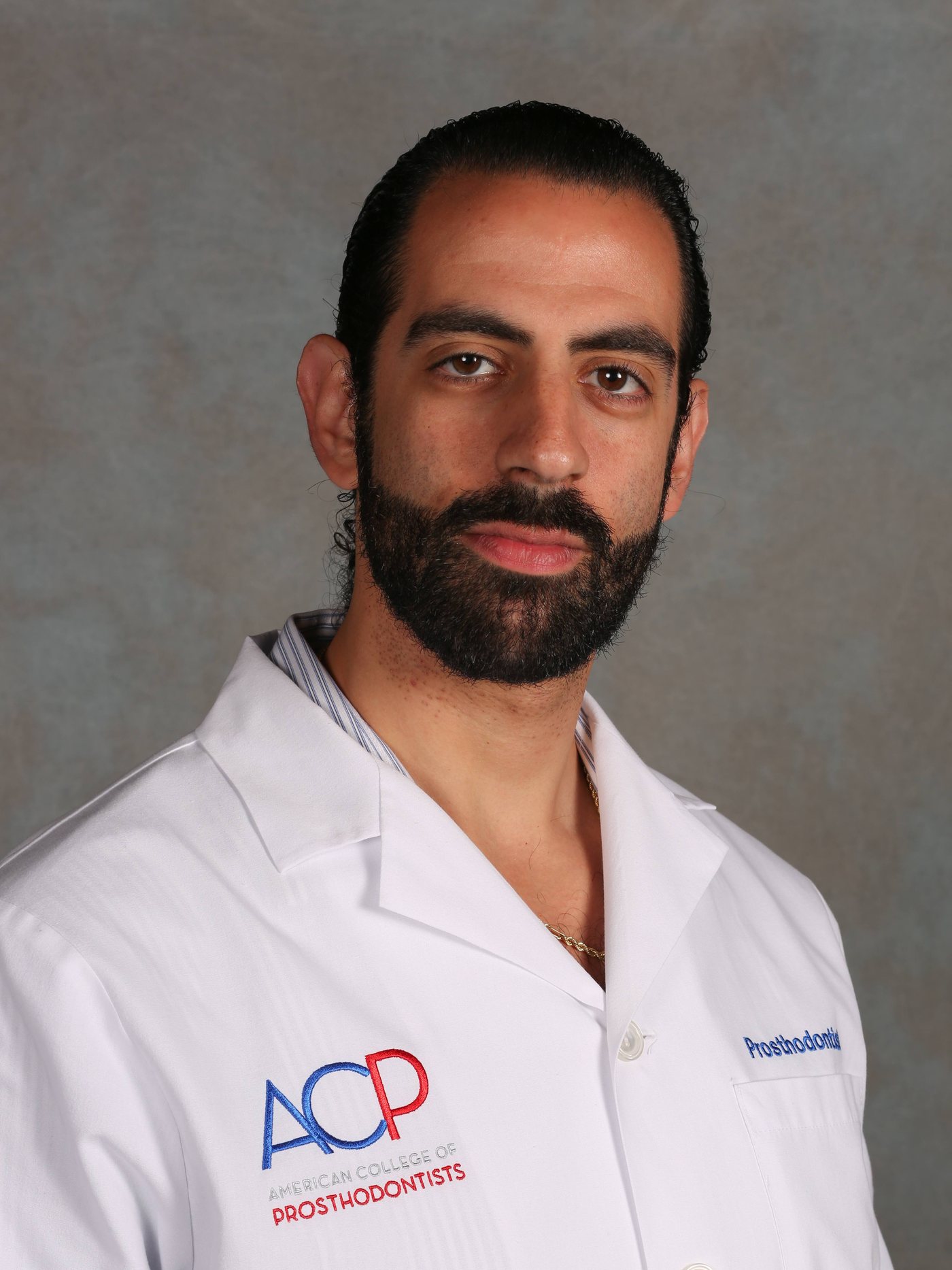 Dr. Jonathan Berkowitz, DMD, prosthodontist, wearing an American College of Prosthodontists coat